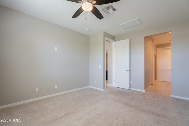 unfurnished bedroom featuring baseboards, visible vents, ceiling fan, and light colored carpet