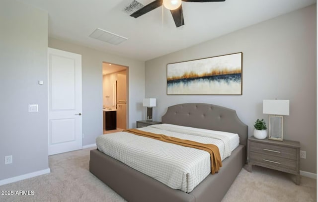 carpeted bedroom featuring baseboards, ceiling fan, and ensuite bath
