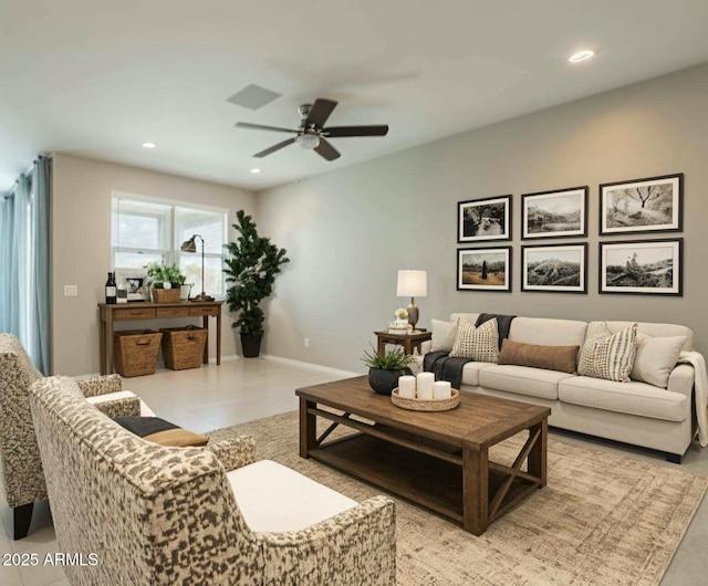 living room with a ceiling fan, recessed lighting, and baseboards