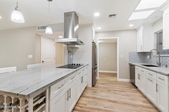 kitchen with visible vents, appliances with stainless steel finishes, island range hood, and a sink