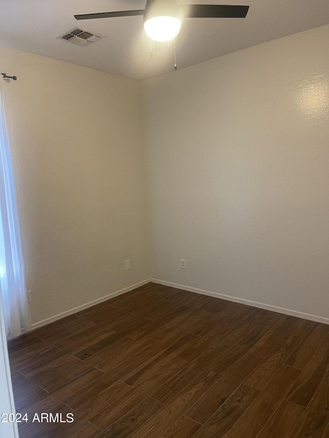 spare room featuring ceiling fan and dark hardwood / wood-style flooring