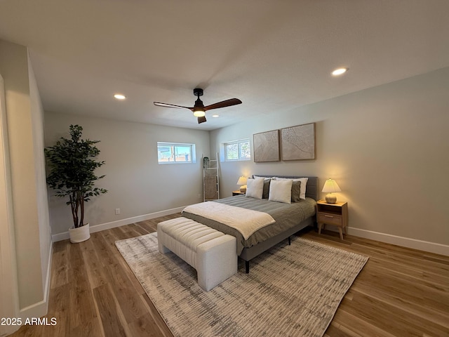 bedroom with recessed lighting, baseboards, and wood finished floors