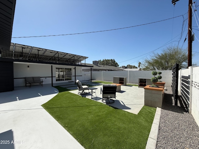 view of yard featuring a fenced backyard, an outdoor fire pit, and a patio