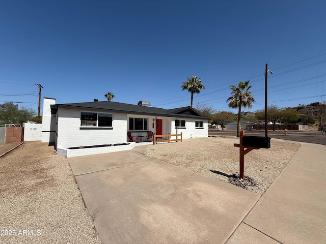 single story home featuring fence