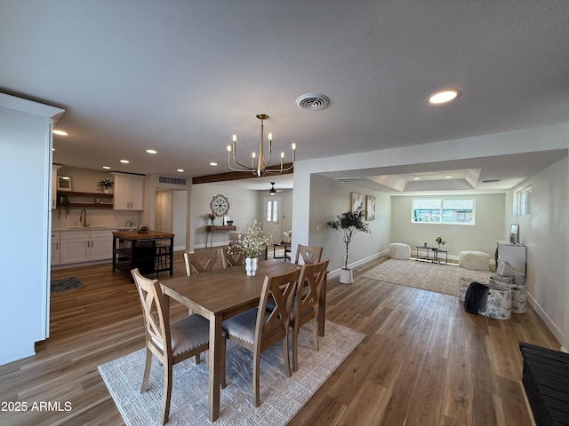 dining space featuring recessed lighting, baseboards, and wood finished floors