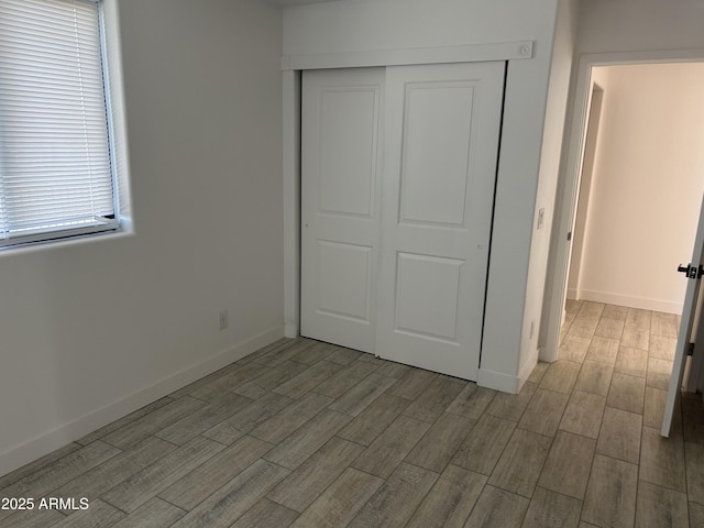 4602 N 47th Ave N, Phoenix, AZ 85031 - unfurnished bedroom featuring wood finished floors, a closet, and baseboards