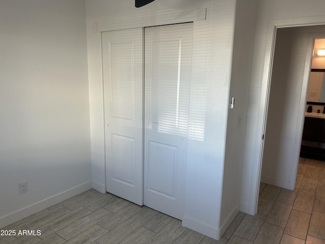 4602 N 47th Ave N, Phoenix, AZ 85031 - unfurnished bedroom with wood tiled floors, a closet, and baseboards