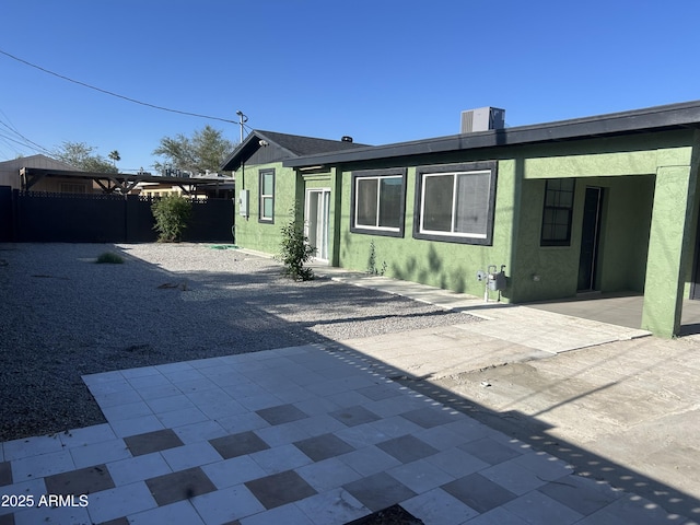 4602 N 47th Ave N, Phoenix, AZ 85031 - rear view of house with fence, a patio area, stucco siding, and central AC unit