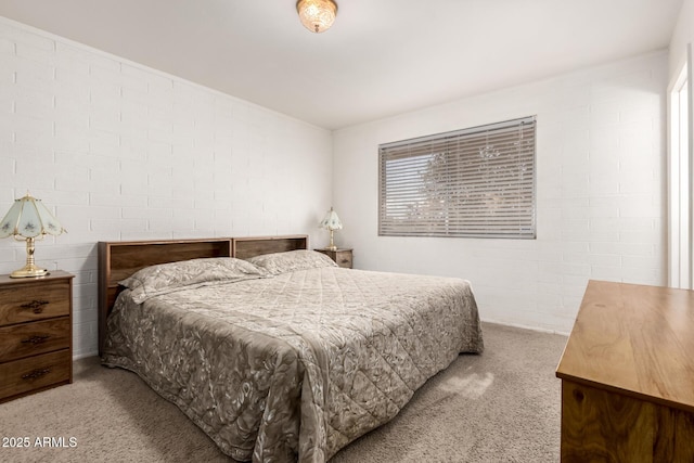 carpeted bedroom with brick wall