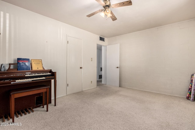 sitting room featuring visible vents, carpet, and ceiling fan