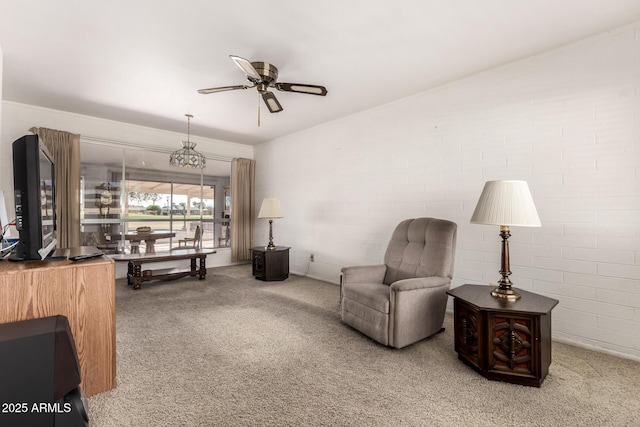 sitting room with a ceiling fan and carpet flooring