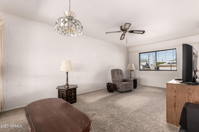 sitting room with a ceiling fan and carpet flooring