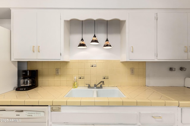 kitchen featuring white cabinets, white dishwasher, backsplash, and a sink