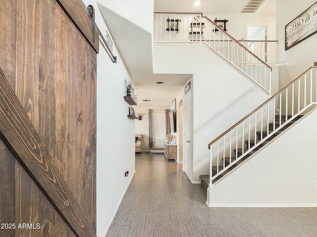 interior space with a high ceiling and a barn door