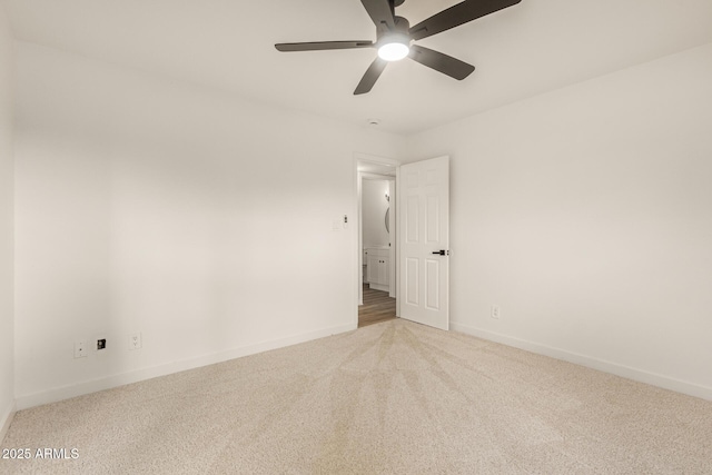 spare room featuring a ceiling fan, carpet flooring, and baseboards