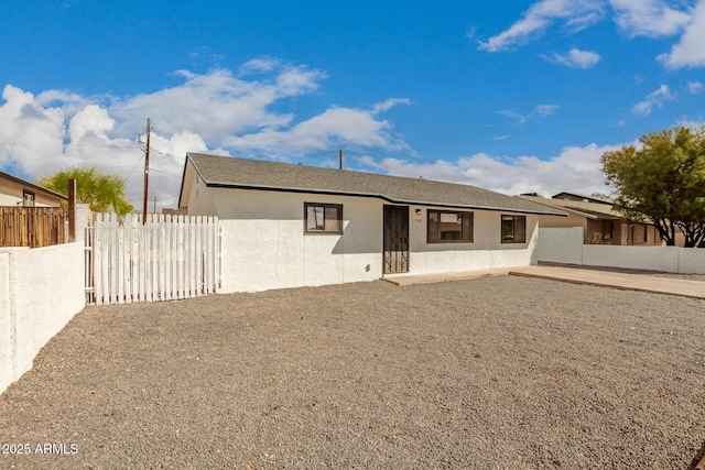 back of property featuring a fenced backyard, a patio, and stucco siding