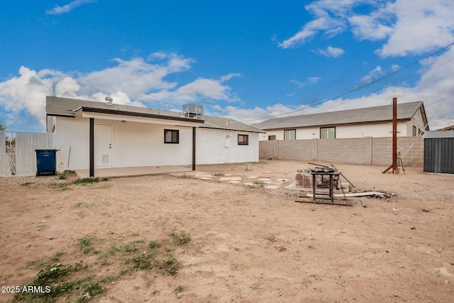 back of property with cooling unit, a patio area, a fenced backyard, and stucco siding