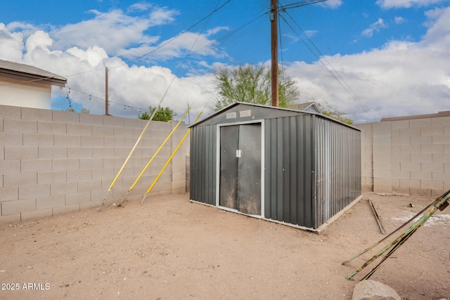 view of shed with a fenced backyard