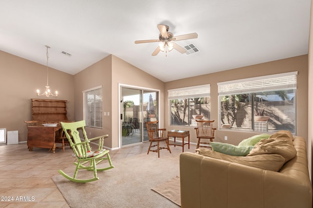 living room featuring vaulted ceiling, light tile patterned floors, and ceiling fan with notable chandelier