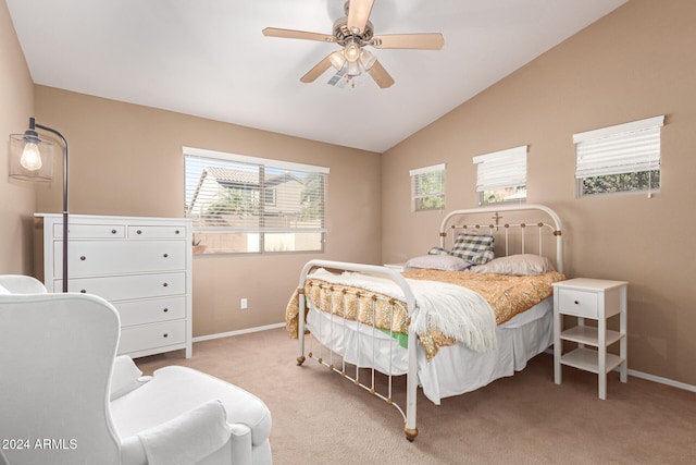 carpeted bedroom with ceiling fan and vaulted ceiling