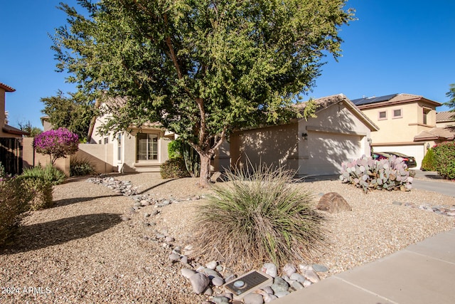 view of property hidden behind natural elements with a garage