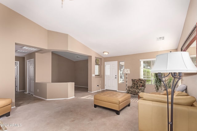 living room with light carpet and vaulted ceiling