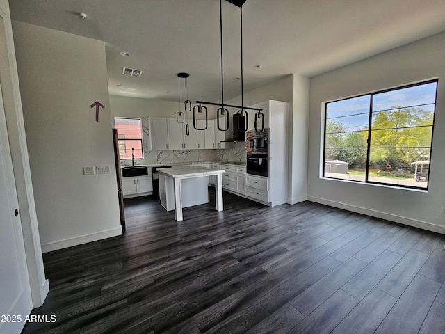 1401 S Rita Ln, Tempe, AZ 85281 - kitchen featuring white cabinets, dark wood-style floors, light countertops, and tasteful backsplash