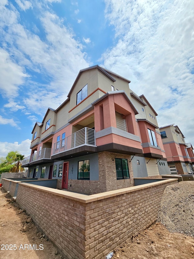 1401 S Rita Ln, Tempe, AZ 85281 - view of home's exterior featuring brick siding and a balcony