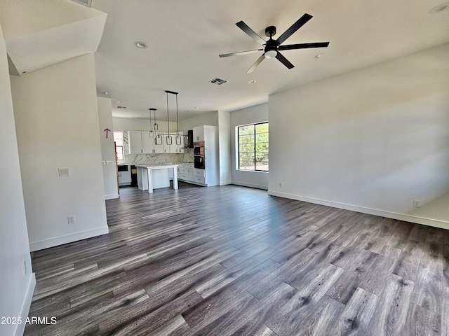 1401 S Rita Ln, Tempe, AZ 85281 - unfurnished living room featuring dark wood-type flooring and ceiling fan