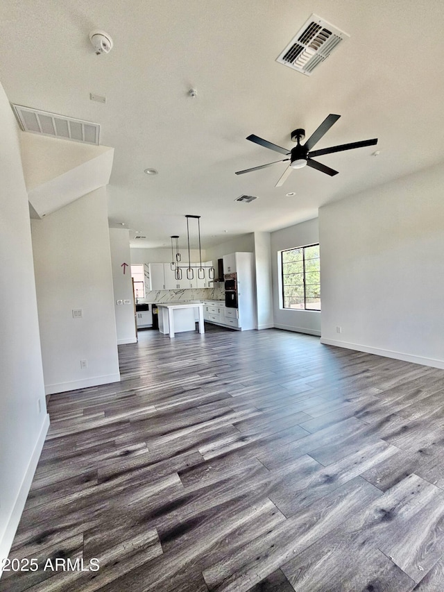 1401 S Rita Ln, Tempe, AZ 85281 - unfurnished living room featuring dark wood-type flooring and a ceiling fan