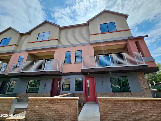1401 S Rita Ln, Tempe, AZ 85281 - townhome / multi-family property with stucco siding, a balcony, and brick siding