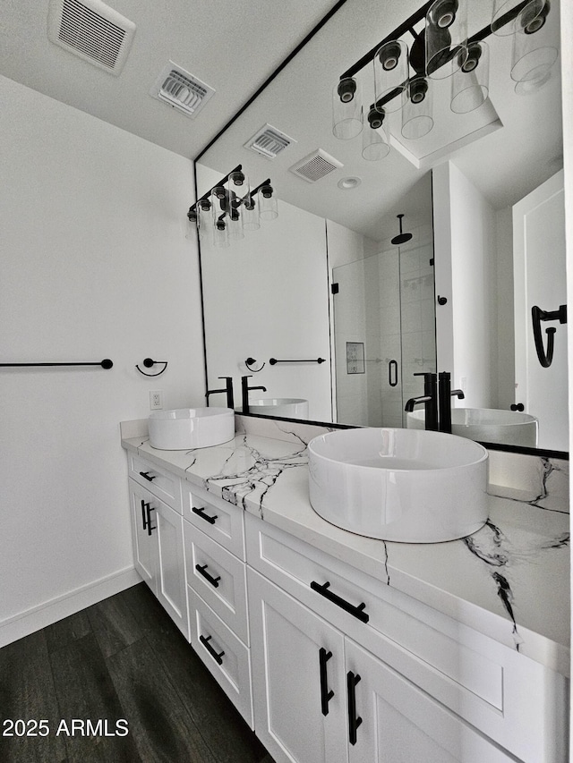 1401 S Rita Ln, Tempe, AZ 85281 - full bathroom featuring a stall shower, double vanity, and wood finished floors