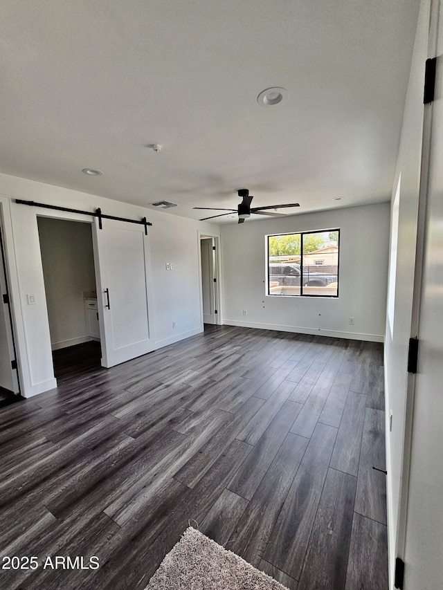 1401 S Rita Ln, Tempe, AZ 85281 - spare room featuring a barn door, dark wood finished floors, ceiling fan, and recessed lighting