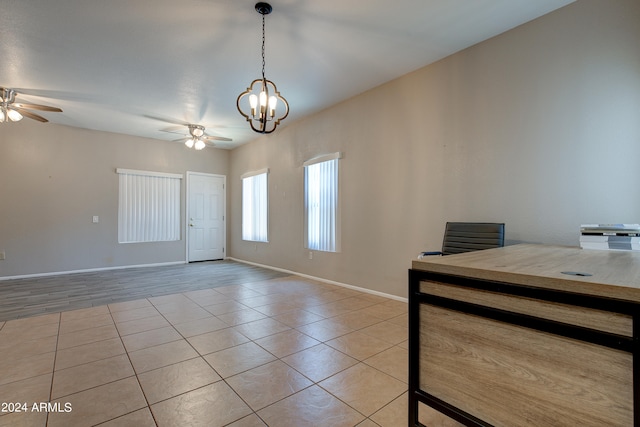 entrance foyer with ceiling fan with notable chandelier, light tile patterned flooring, and baseboards