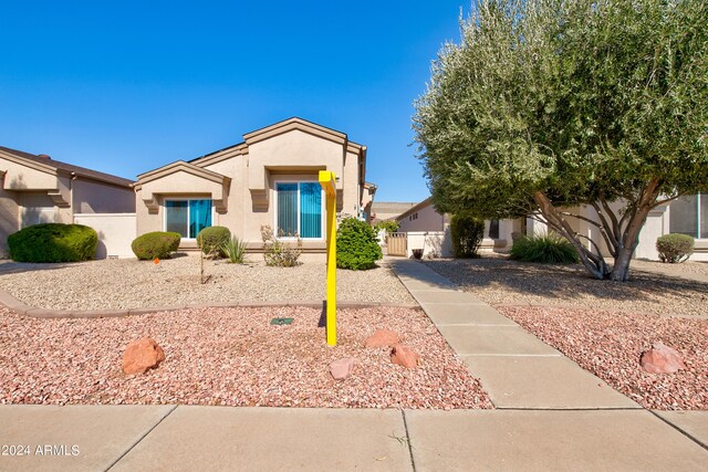 view of front of house with fence and stucco siding