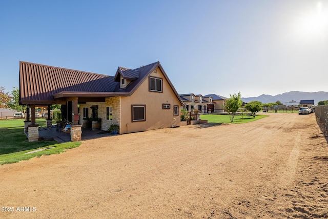 7738 N 185th Ave, Waddell, AZ 85355 - back of property with fence, stone siding, stucco siding, a mountain view, and a patio