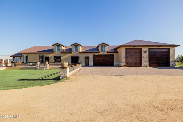 7738 N 185th Ave, Waddell, AZ 85355 - french country style house featuring metal roof, a front lawn, stone siding, and stucco siding
