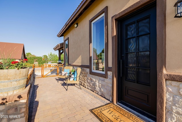 7738 N 185th Ave, Waddell, AZ 85355 - property entrance with fence, stone siding, and stucco siding