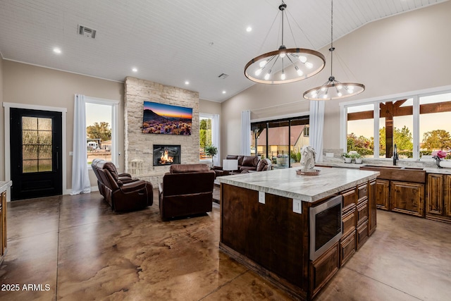 7738 N 185th Ave, Waddell, AZ 85355 - kitchen featuring light countertops, stainless steel microwave, high vaulted ceiling, and finished concrete flooring