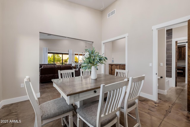 7738 N 185th Ave, Waddell, AZ 85355 - dining room featuring a high ceiling, visible vents, baseboards, and finished concrete flooring