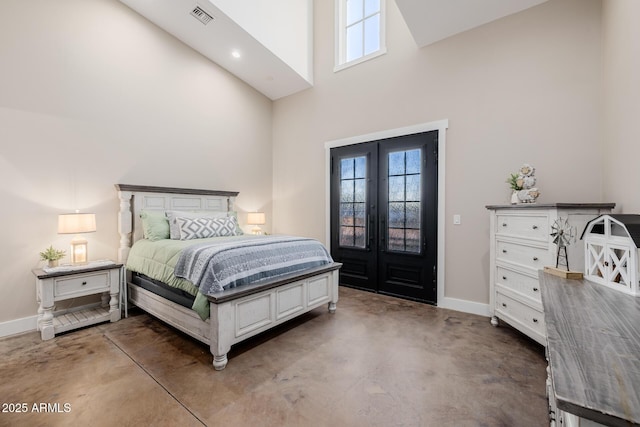 7738 N 185th Ave, Waddell, AZ 85355 - bedroom featuring baseboards, concrete floors, multiple windows, and a towering ceiling