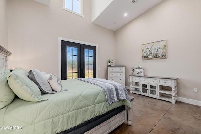 7738 N 185th Ave, Waddell, AZ 85355 - bedroom featuring multiple windows, access to exterior, a towering ceiling, baseboards, and concrete floors