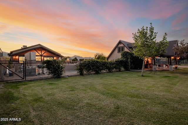 7738 N 185th Ave, Waddell, AZ 85355 - yard at dusk featuring fence, a patio, and a gazebo