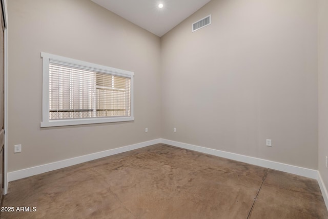 7738 N 185th Ave, Waddell, AZ 85355 - spare room with visible vents, baseboards, concrete flooring, and lofted ceiling