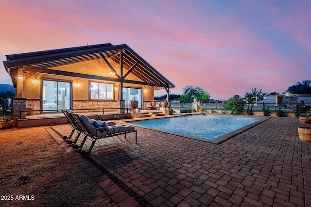 7738 N 185th Ave, Waddell, AZ 85355 - pool at dusk featuring fence, a patio area, and an outdoor pool