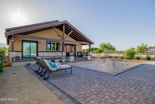 7738 N 185th Ave, Waddell, AZ 85355 - exterior space featuring fence, stucco siding, a patio area, and stone siding