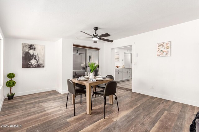 dining area with ceiling fan and dark hardwood / wood-style flooring