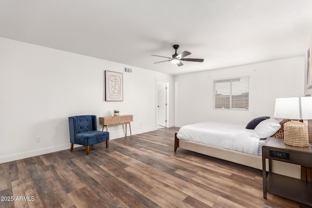 bedroom with ceiling fan and dark hardwood / wood-style flooring