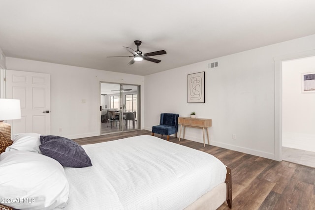 bedroom with ceiling fan and dark wood-type flooring