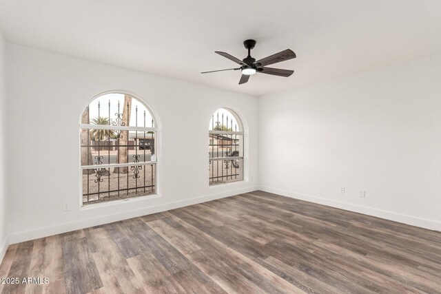 empty room with hardwood / wood-style flooring and ceiling fan